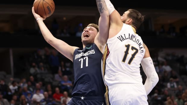 Nov 8, 2021; Dallas, Texas, USA; Dallas Mavericks guard Luka Doncic (77) shoots as New Orleans Pelicans center Jonas Valanciunas (17) defends during the fourth quarter at American Airlines Center. Mandatory Credit: Kevin Jairaj-USA TODAY Sports